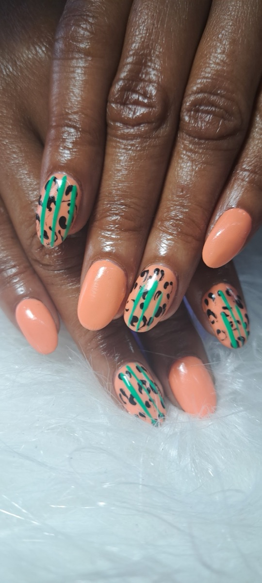 Peach nails with black leopard print and neon-green stripe accents