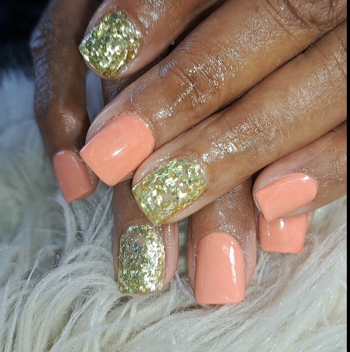 Peach gel nails with gold flake glitter accent nails